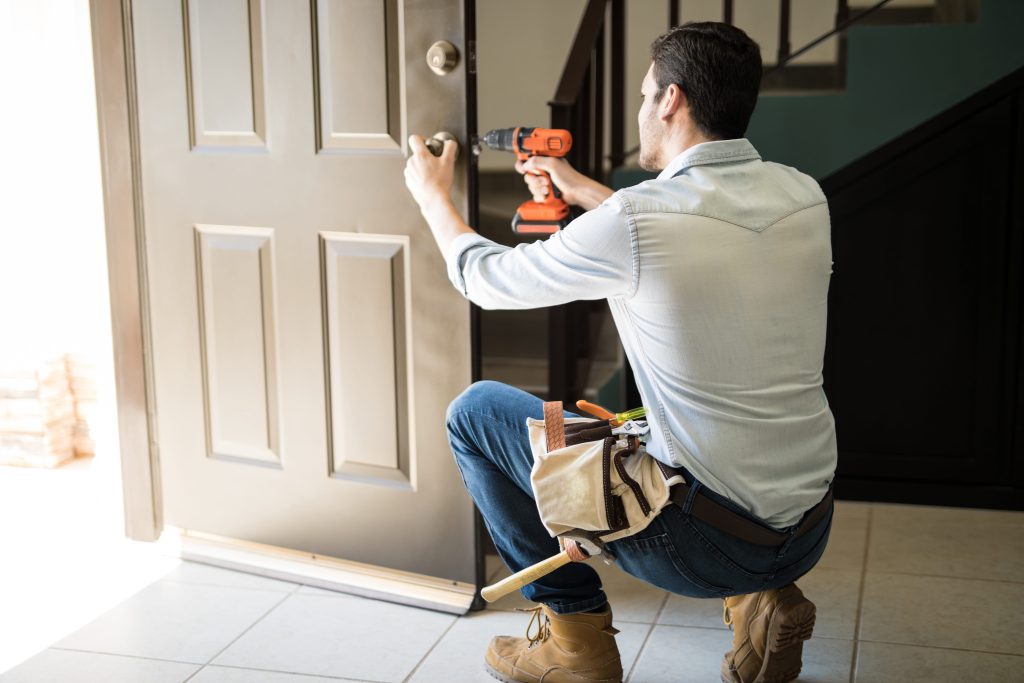 handyman fixing door knob