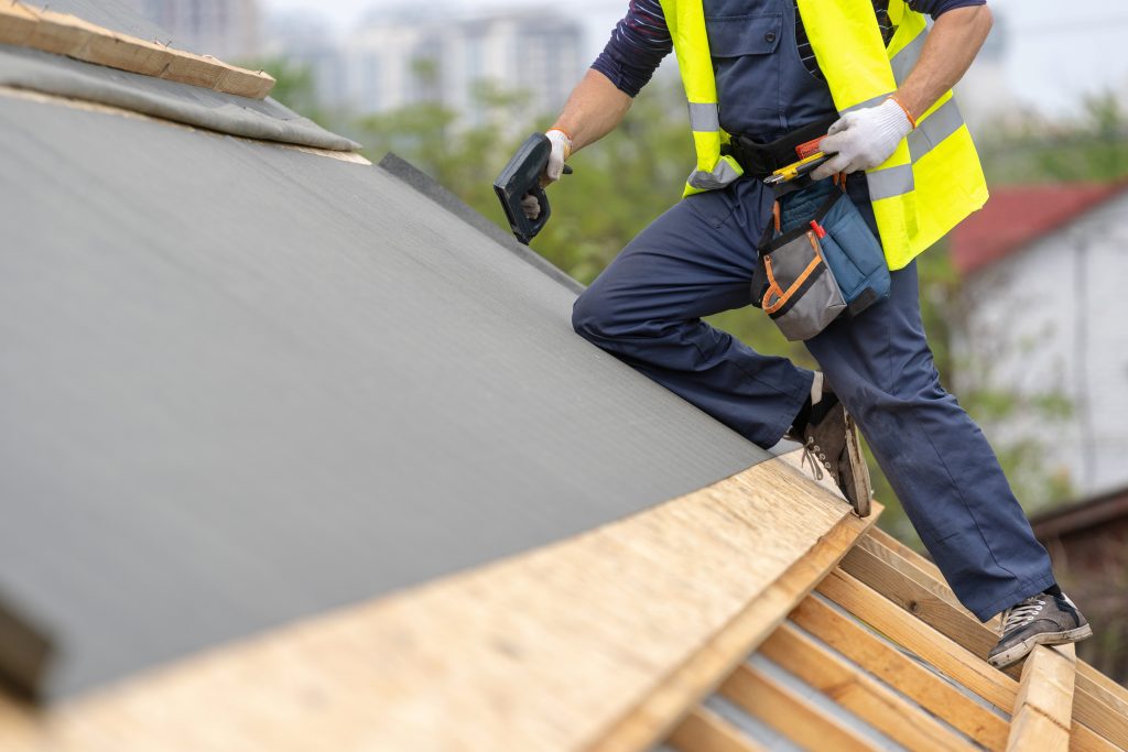 roofing tech on sloped roof